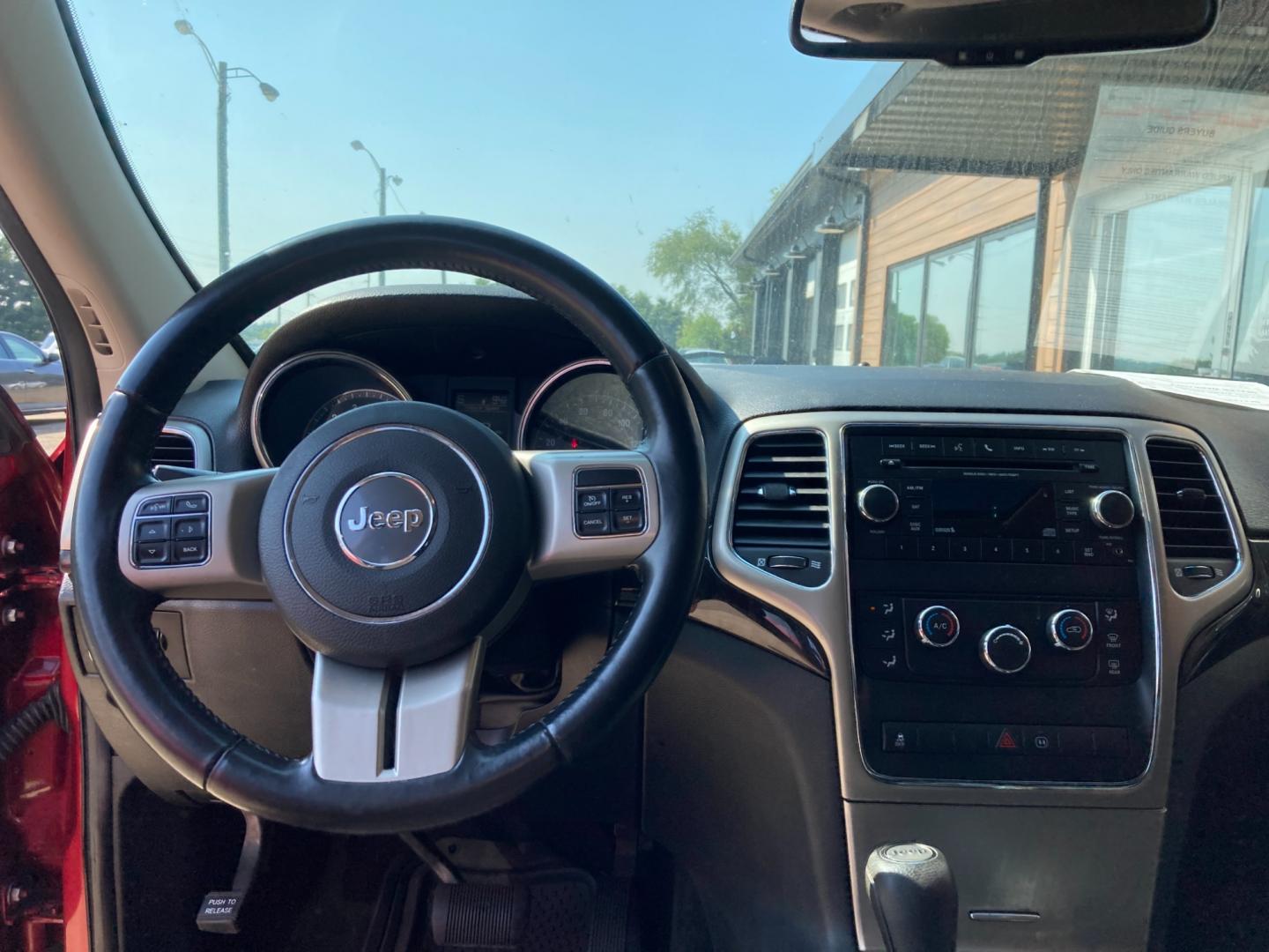 2012 Ruby Red Met Jeep Grand Cherokee Laredo 4WD (1C4RJFAG4CC) with an 3.6L V6 DOHC 24V engine, 5-Speed Automatic transmission, located at 1800 South Ihm Blvd, Freeport, IL, 61032, (815) 232-5543, 42.278645, -89.607994 - Photo#7