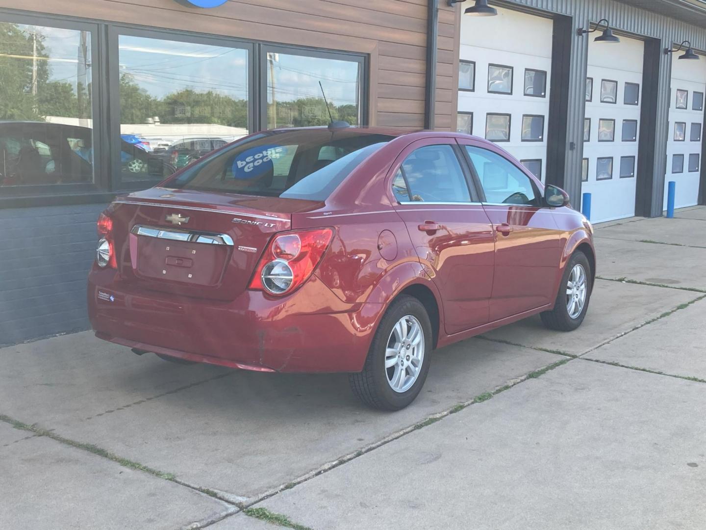 2015 Firethorn Red Met. Chevrolet Sonic LT Auto Sedan (1G1JC5SB8F4) with an 1.4L L4 DOHC 24V TURBO engine, 6-Speed Automatic transmission, located at 1800 South Ihm Blvd, Freeport, IL, 61032, (815) 232-5543, 42.278645, -89.607994 - Sonic LT 4D Sedan - Photo#4